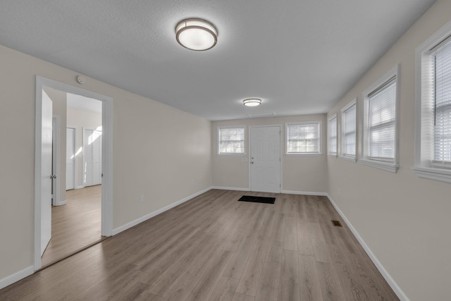 entryway featuring light hardwood / wood-style floors and a textured ceiling