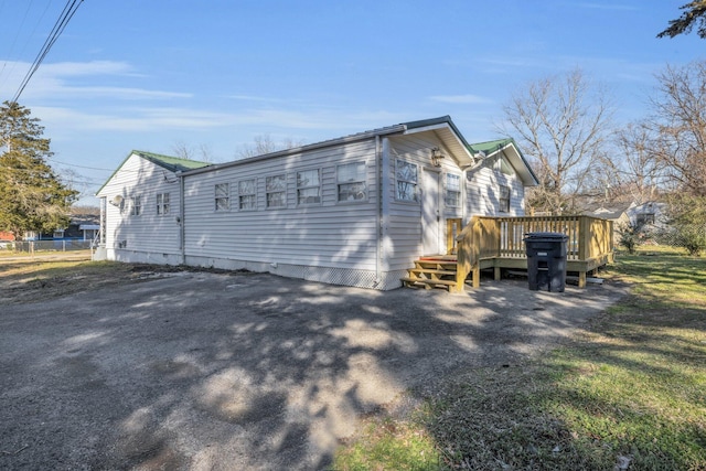 view of side of property with a wooden deck