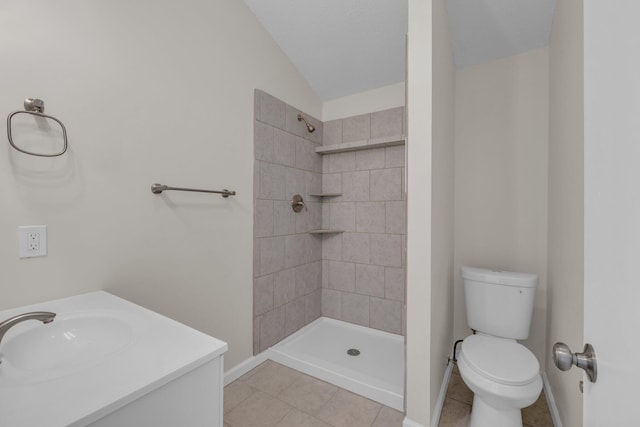 bathroom with toilet, tiled shower, lofted ceiling, and vanity