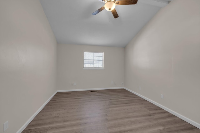 unfurnished room featuring ceiling fan, vaulted ceiling, and light wood-type flooring