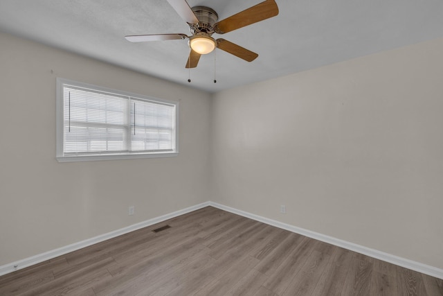 spare room with light hardwood / wood-style floors and ceiling fan