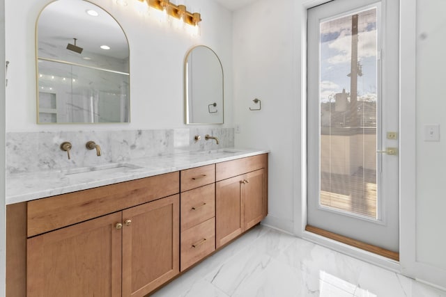 bathroom featuring a shower with shower door and vanity