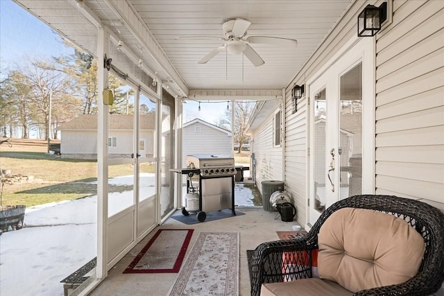 sunroom / solarium featuring ceiling fan and a wealth of natural light