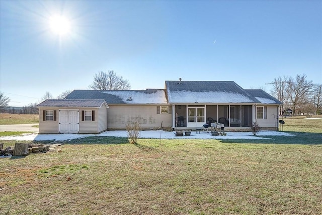 rear view of property with a patio area, a yard, and a sunroom