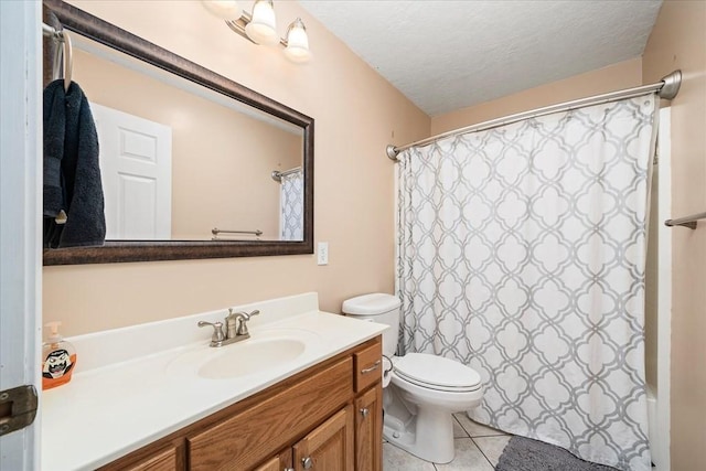 bathroom featuring a textured ceiling, tile patterned floors, vanity, and toilet