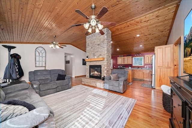 living room featuring a fireplace, vaulted ceiling, wood ceiling, and light wood-type flooring