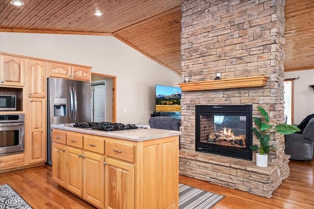 kitchen featuring light brown cabinetry, a fireplace, wood ceiling, light wood-type flooring, and stainless steel appliances