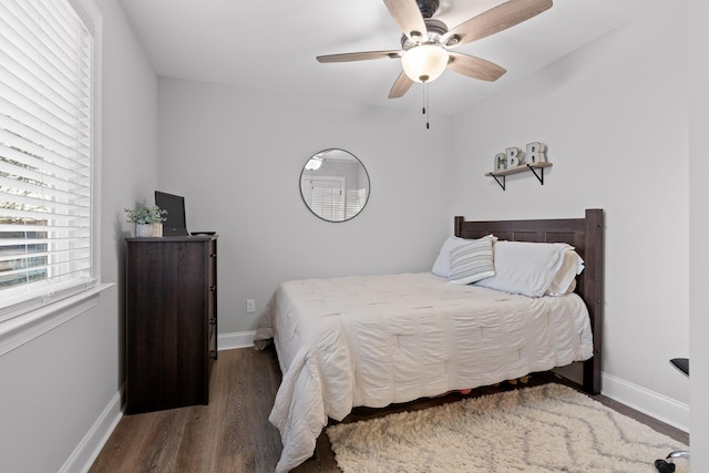 bedroom with ceiling fan and dark wood-type flooring