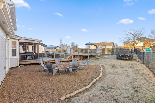 view of yard featuring a deck and a fire pit