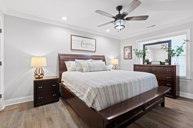 bedroom with ceiling fan, hardwood / wood-style floors, and crown molding