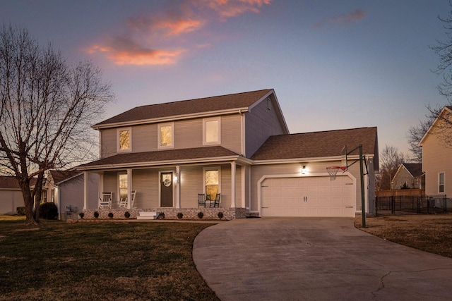 view of front of property with a porch, a garage, and a lawn