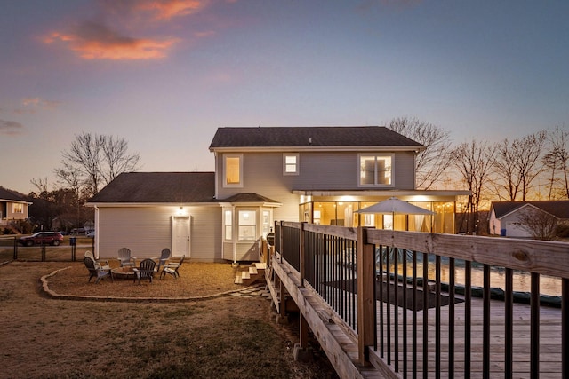 back house at dusk with a fire pit