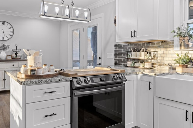 kitchen with crown molding, white cabinetry, hanging light fixtures, electric range, and backsplash