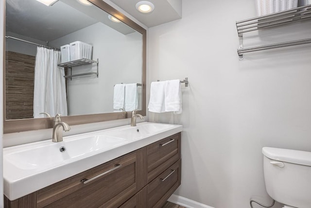 bathroom with vanity, toilet, and a shower with shower curtain