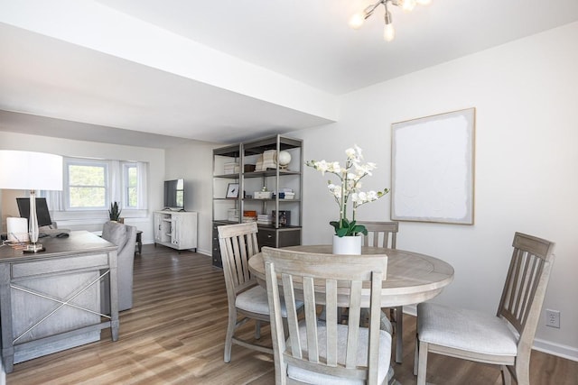 dining room featuring hardwood / wood-style flooring and a chandelier