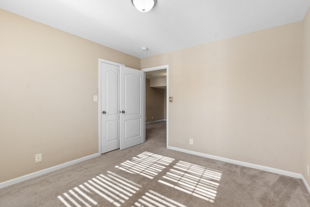 unfurnished bedroom with light colored carpet