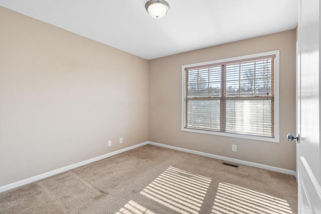 spare room with light colored carpet