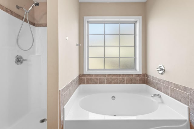 bathroom featuring shower with separate bathtub