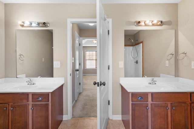 bathroom with tile patterned flooring, walk in shower, and vanity