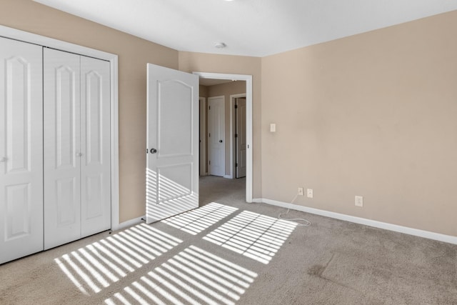 unfurnished bedroom featuring a closet and light carpet