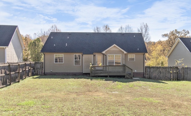 back of house featuring a lawn and a wooden deck