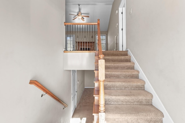 stairs featuring ceiling fan