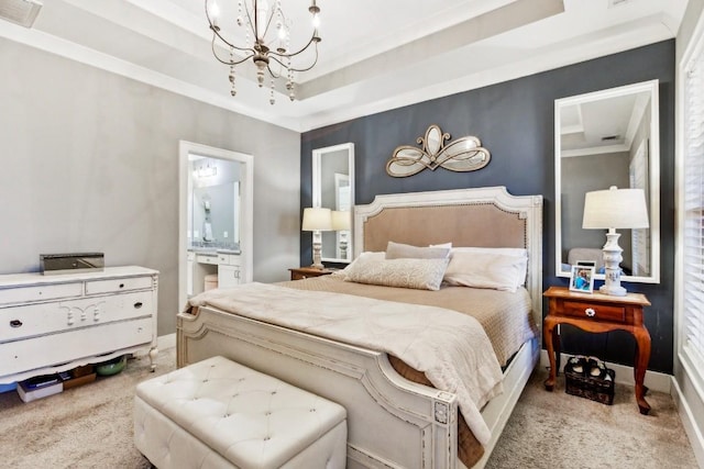 carpeted bedroom with a chandelier, ensuite bathroom, a raised ceiling, and ornamental molding