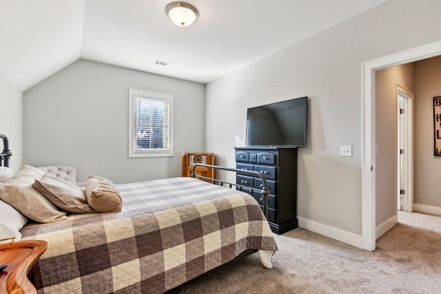 carpeted bedroom featuring lofted ceiling