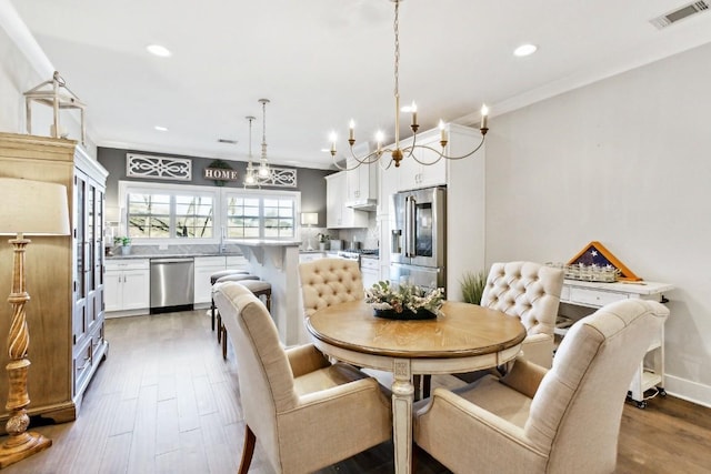 dining room with ornamental molding and dark hardwood / wood-style flooring