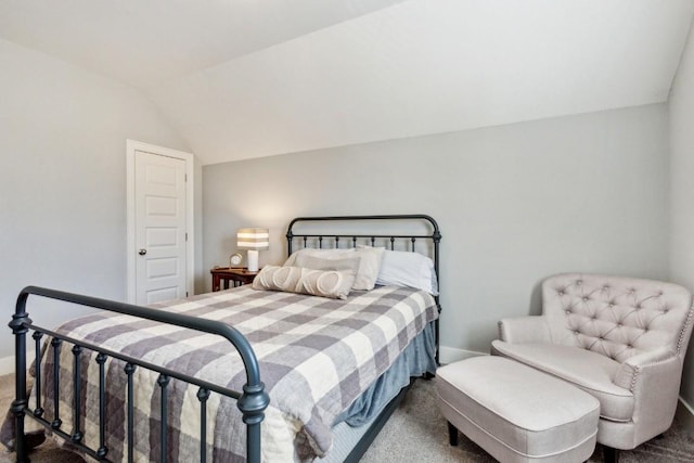 bedroom featuring vaulted ceiling and carpet flooring