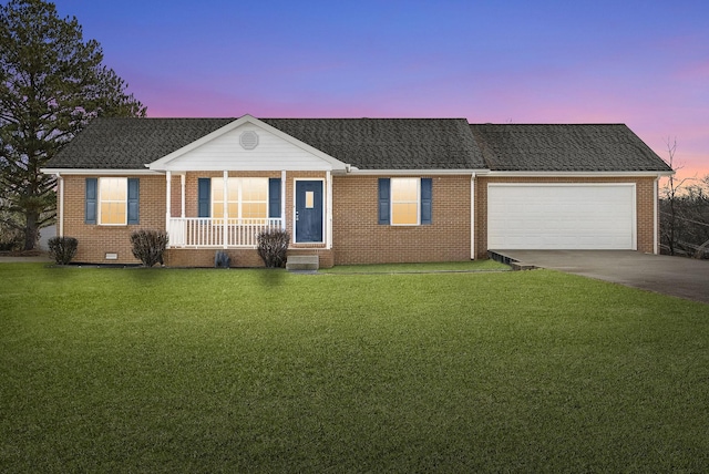 ranch-style house with a garage, a lawn, and covered porch