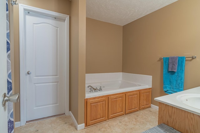 bathroom featuring sink, a textured ceiling, and a bathing tub