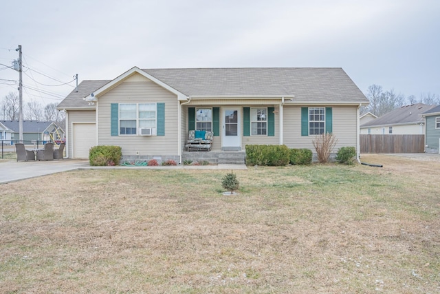 ranch-style house featuring a garage, covered porch, and a front yard