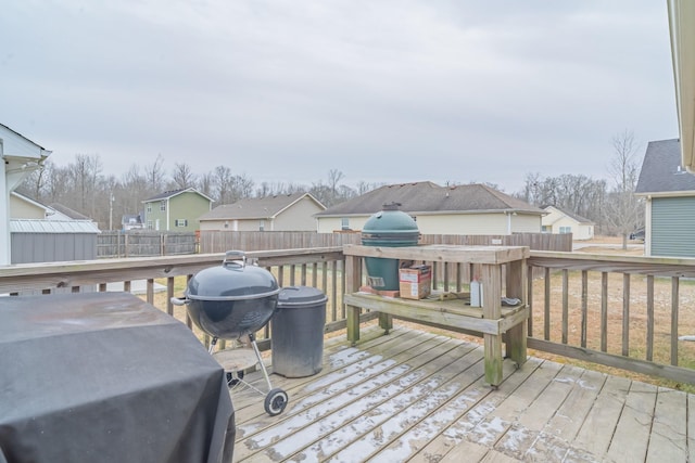 wooden deck featuring a grill