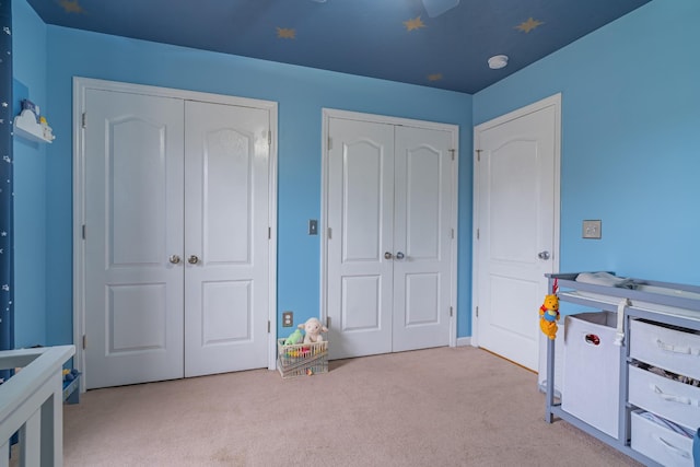 recreation room with light colored carpet