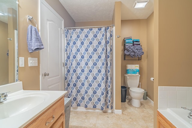 bathroom with toilet, a textured ceiling, and vanity