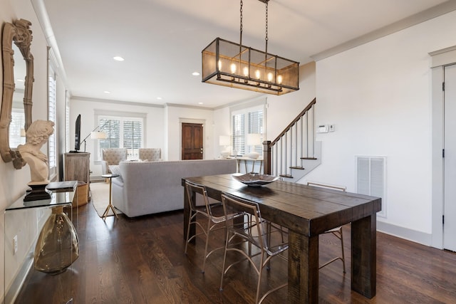 dining space featuring dark hardwood / wood-style floors and crown molding