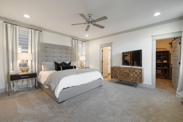 carpeted bedroom with a closet, ceiling fan, and a spacious closet