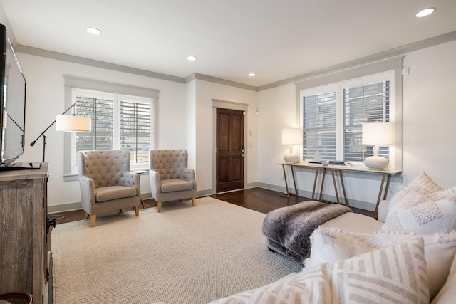 living room featuring dark hardwood / wood-style flooring, crown molding, and a healthy amount of sunlight