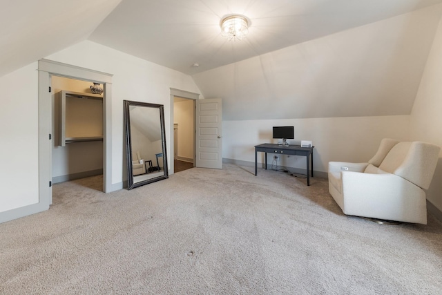 interior space featuring light colored carpet and vaulted ceiling