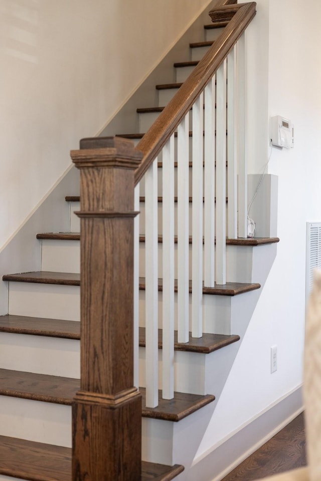 stairway with hardwood / wood-style floors