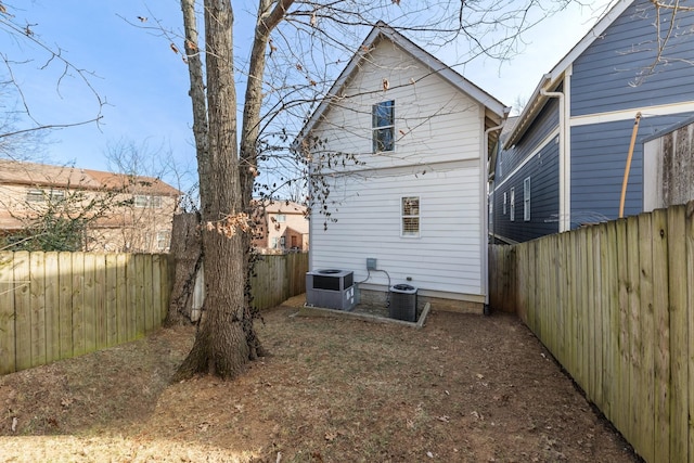 back of house featuring cooling unit