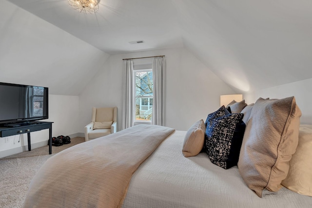 carpeted bedroom with vaulted ceiling