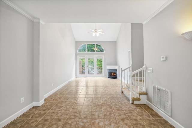 unfurnished living room with crown molding, high vaulted ceiling, light tile patterned floors, and ceiling fan