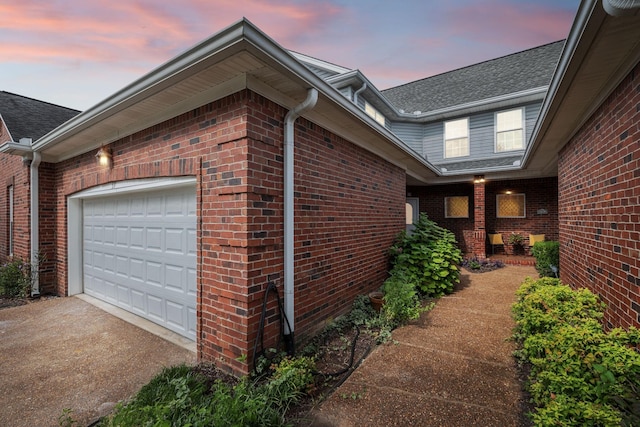 property exterior at dusk featuring a garage