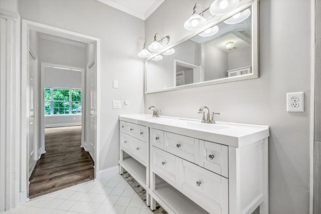 bathroom with vanity, crown molding, and tile patterned flooring