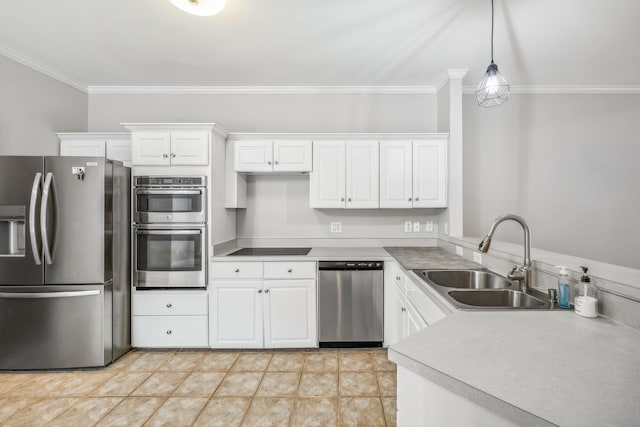 kitchen with sink, hanging light fixtures, white cabinets, and stainless steel appliances