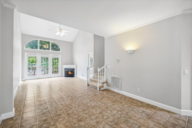 unfurnished living room with ceiling fan, light tile patterned floors, high vaulted ceiling, and ornamental molding