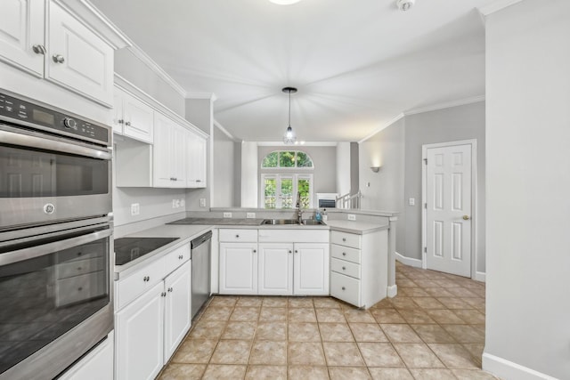 kitchen with decorative light fixtures, white cabinets, kitchen peninsula, and appliances with stainless steel finishes