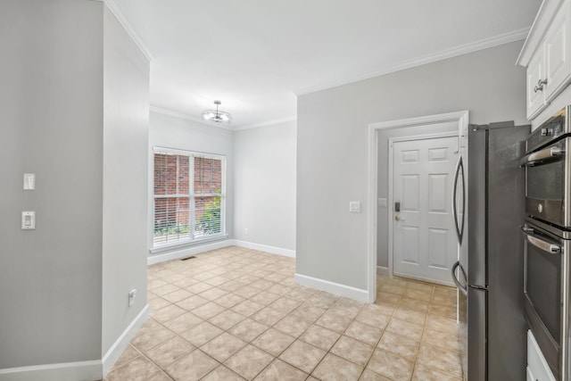 kitchen featuring ornamental molding, white cabinetry, light tile patterned flooring, and appliances with stainless steel finishes